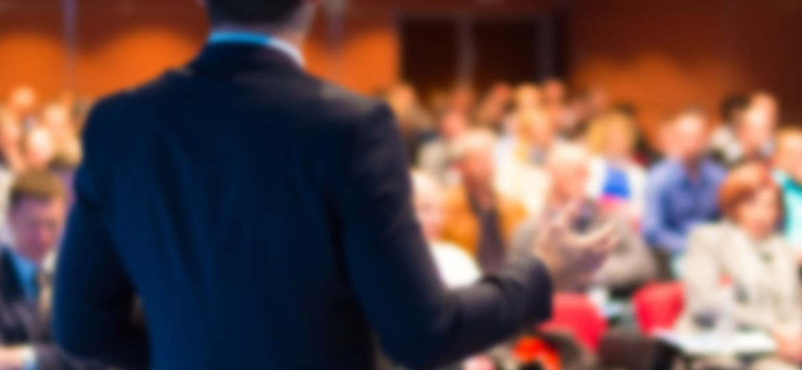 man giving presentation in front of an audience