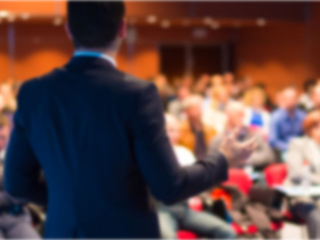 man giving presentation in front of an audience